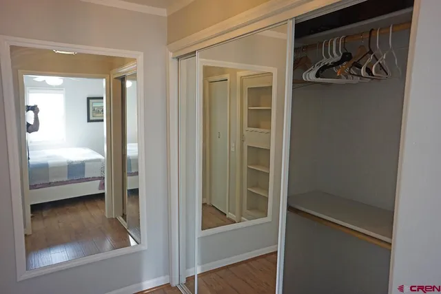 a view of a bedroom with wooden floor