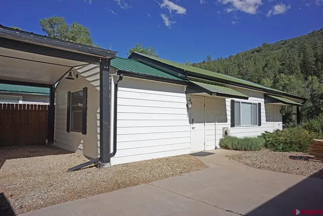 a kitchen with stainless steel appliances granite countertop a refrigerator a stove a sink dishwasher and microwave oven with wooden floor