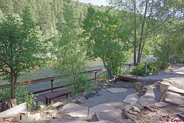 a view of backyard with outdoor seating and green space