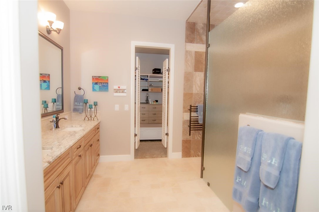 2265 Hyperion Lane Reno, NV 89521 - Photo 11 of 16 a bathroom with a double vanity sink a mirror and a shower