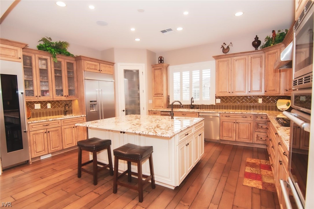 2265 Hyperion Lane Reno, NV 89521 - Photo 3 of 16 a large kitchen with a large counter top space a sink stainless steel appliances and cabinets