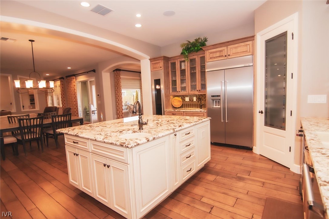 2265 Hyperion Lane Reno, NV 89521 - Photo 6 of 16 a kitchen with stainless steel appliances kitchen island granite countertop a stove and a refrigerator