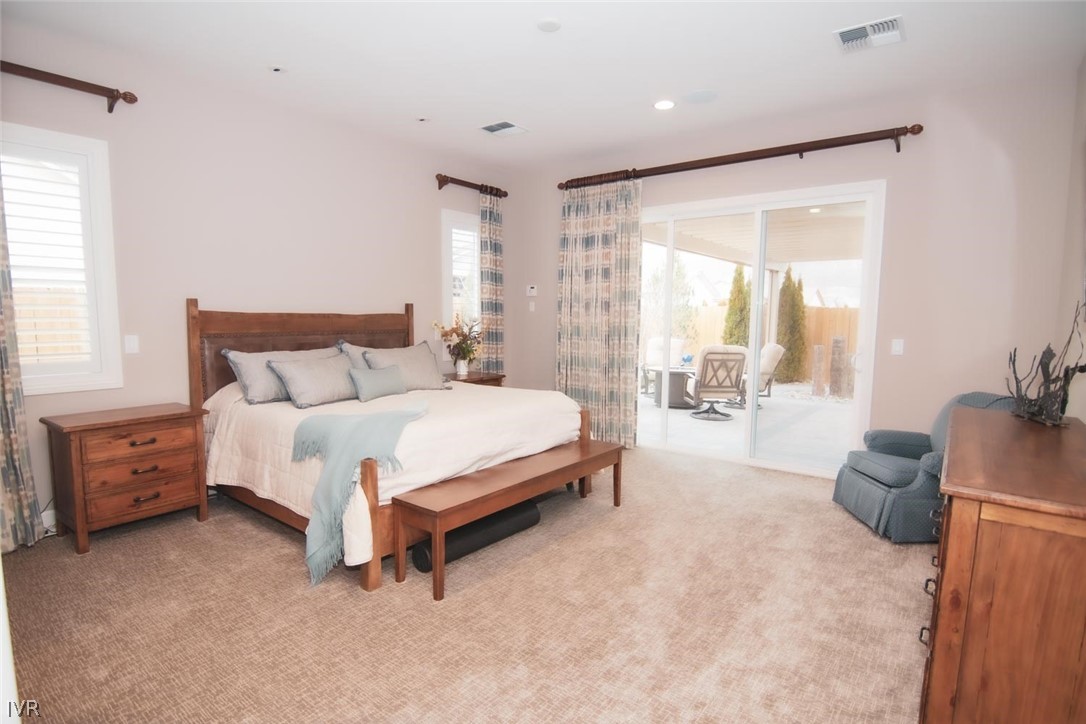 2265 Hyperion Lane Reno, NV 89521 - Photo 10 of 16 a spacious bedroom with a bed and a dresser with mirror