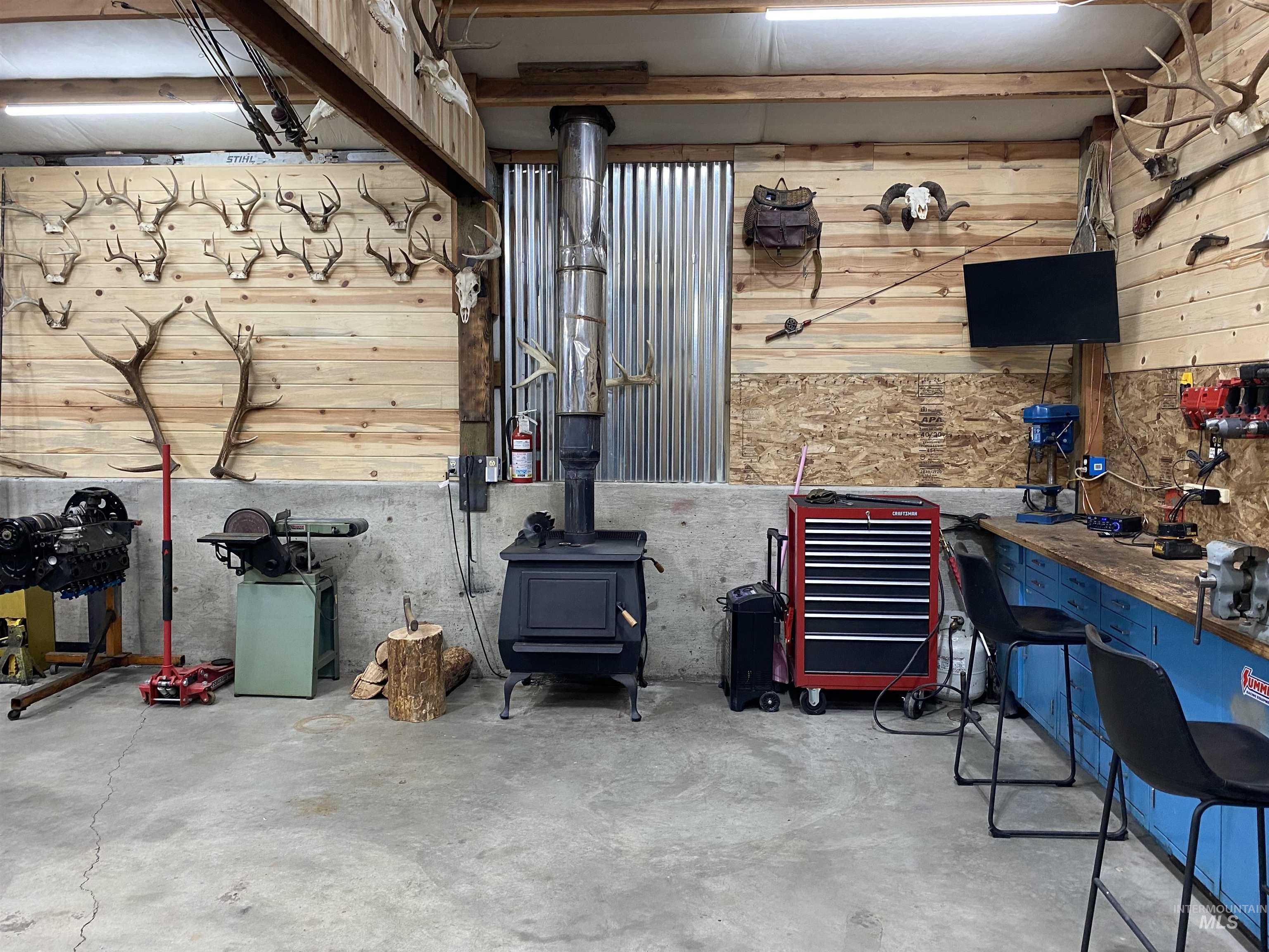 920 Cedar Street Potlatch, ID 83855 - Photo 33 of 41 Miscellaneous room featuring concrete flooring, a workshop area, and wooden walls