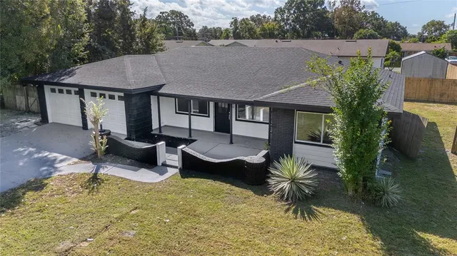 a aerial view of a house with swimming pool and porch