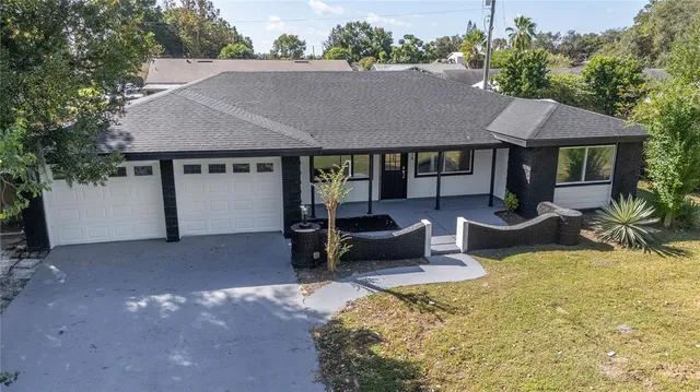 a backyard of a house with yard and outdoor seating