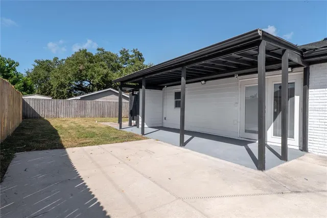 a backyard of a house with table and chairs
