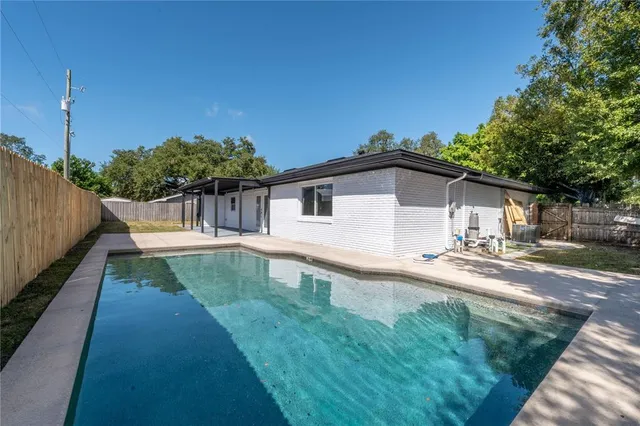 a view of a house with backyard and sitting area