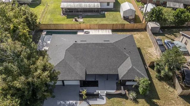 an aerial view of a house with a yard