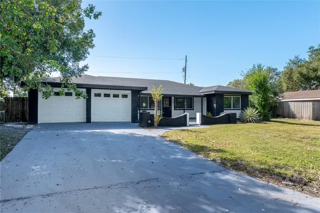 a front view of a house with a yard and a garage