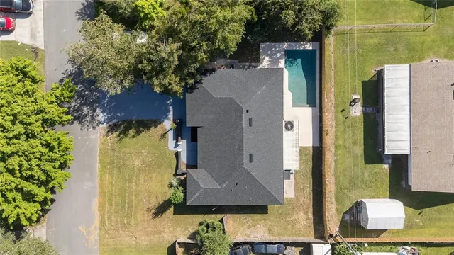 an aerial view of a house with a yard