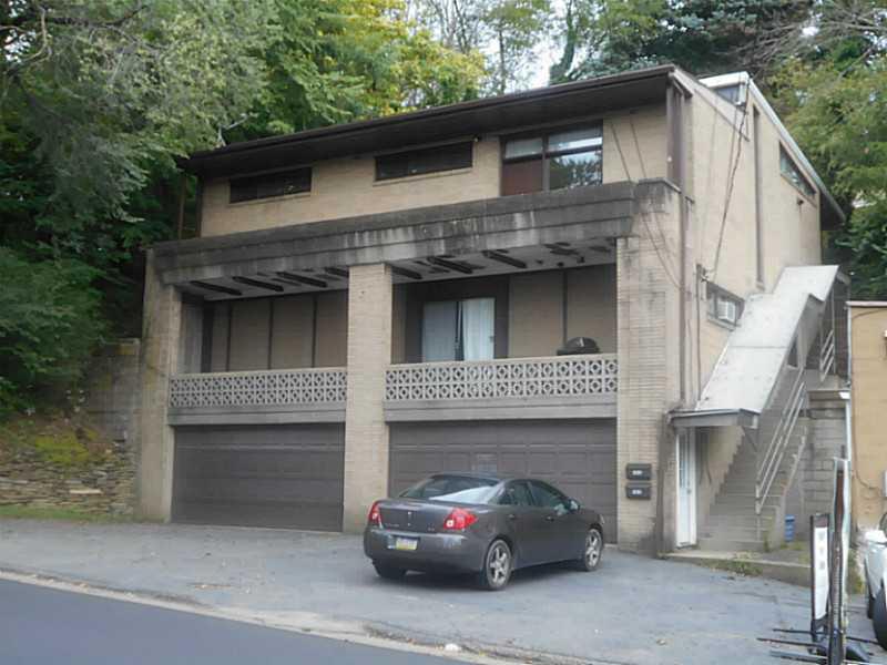 Exterior Front. SOLID BRICK DUPLEX WITH UNIQUE FRANK LLOYD WRIGHT DESIGN. 2 DOUBLE CAR INTEGRAL GARAGES