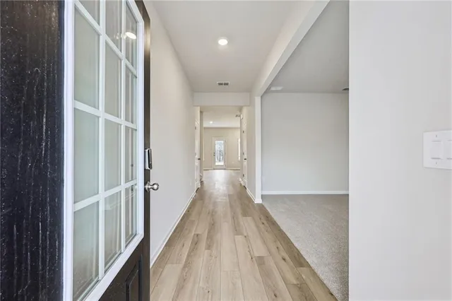 a view of hallway with wooden floor
