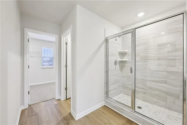 a bathroom with a glass shower door