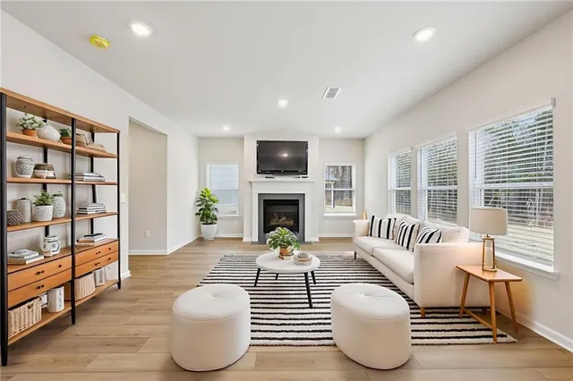 a living room with furniture fireplace and flat screen tv