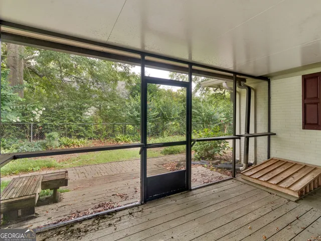 a view of a room with wooden floor and windows