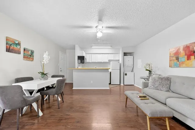 a living room with furniture and kitchen view