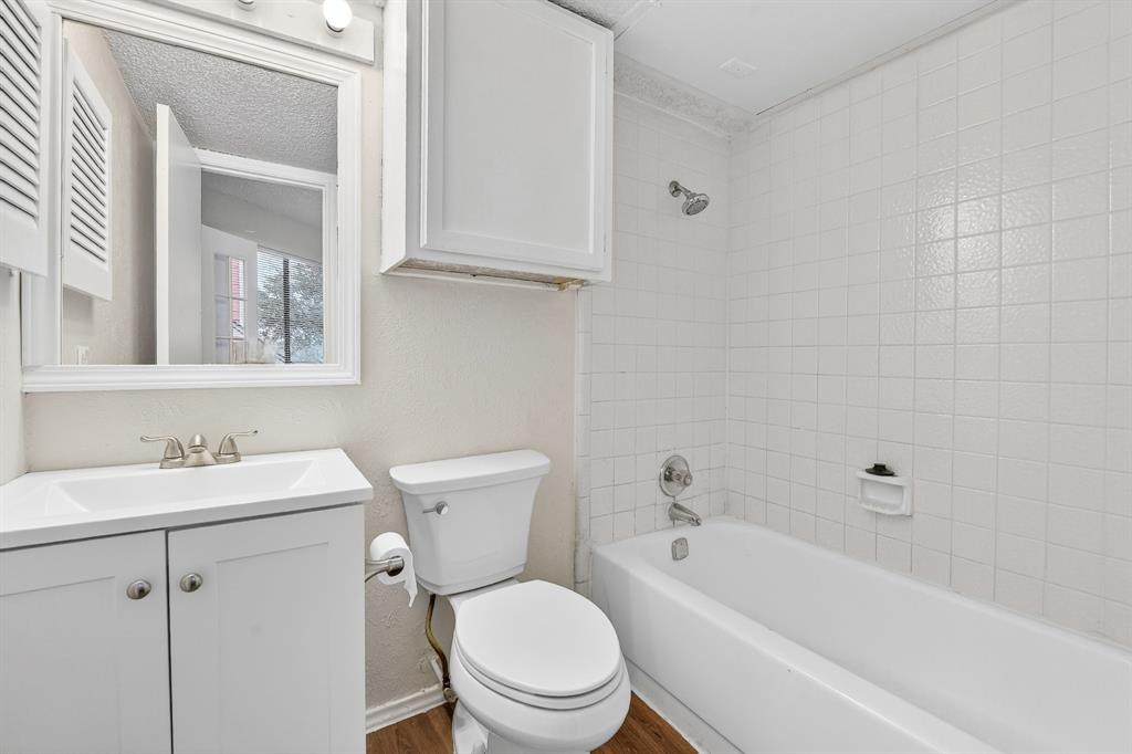 9825 Walnut Street, Unit 306 Dallas, TX 75243 - Photo 21 of 23 a white toilet sitting next to a white bath tub sitting next to a white sink