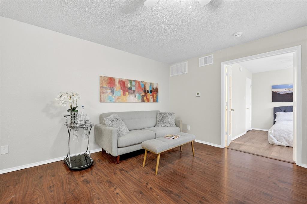 9825 Walnut Street, Unit 306 Dallas, TX 75243 - Photo 9 of 23 a living room with furniture and a wooden floor