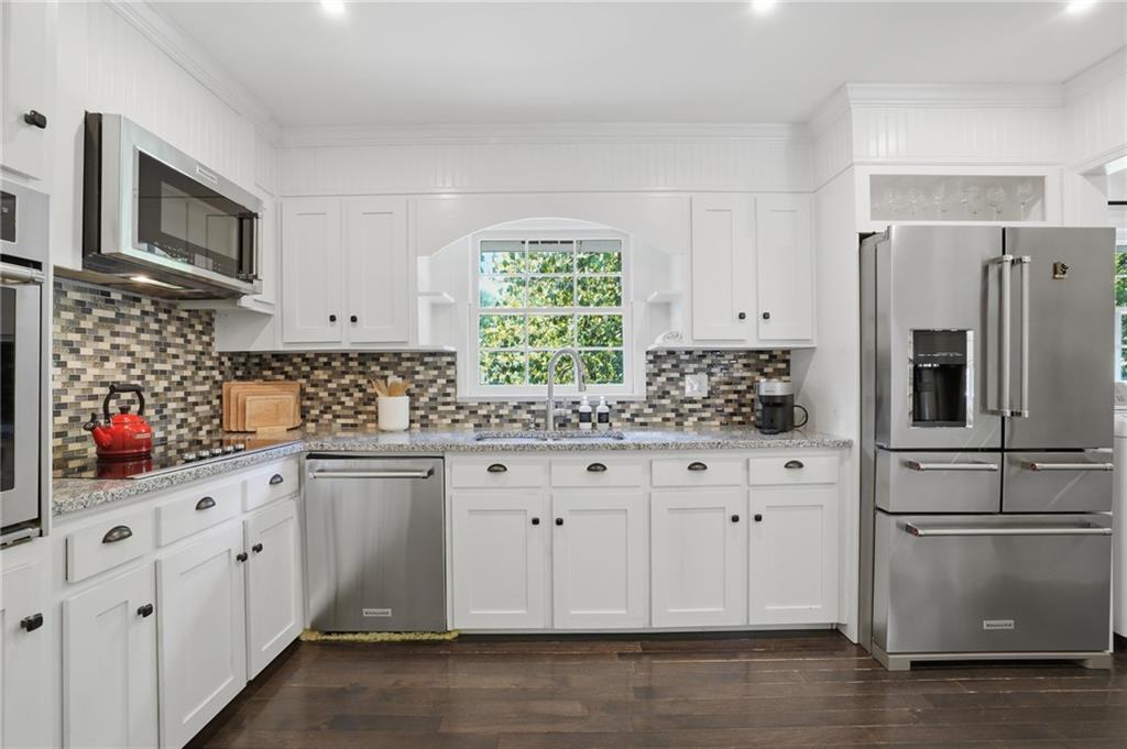 4000 Lower Roswell Road Marietta, GA 30068 - Photo 9 of 25 a kitchen with white cabinets and stainless steel appliances