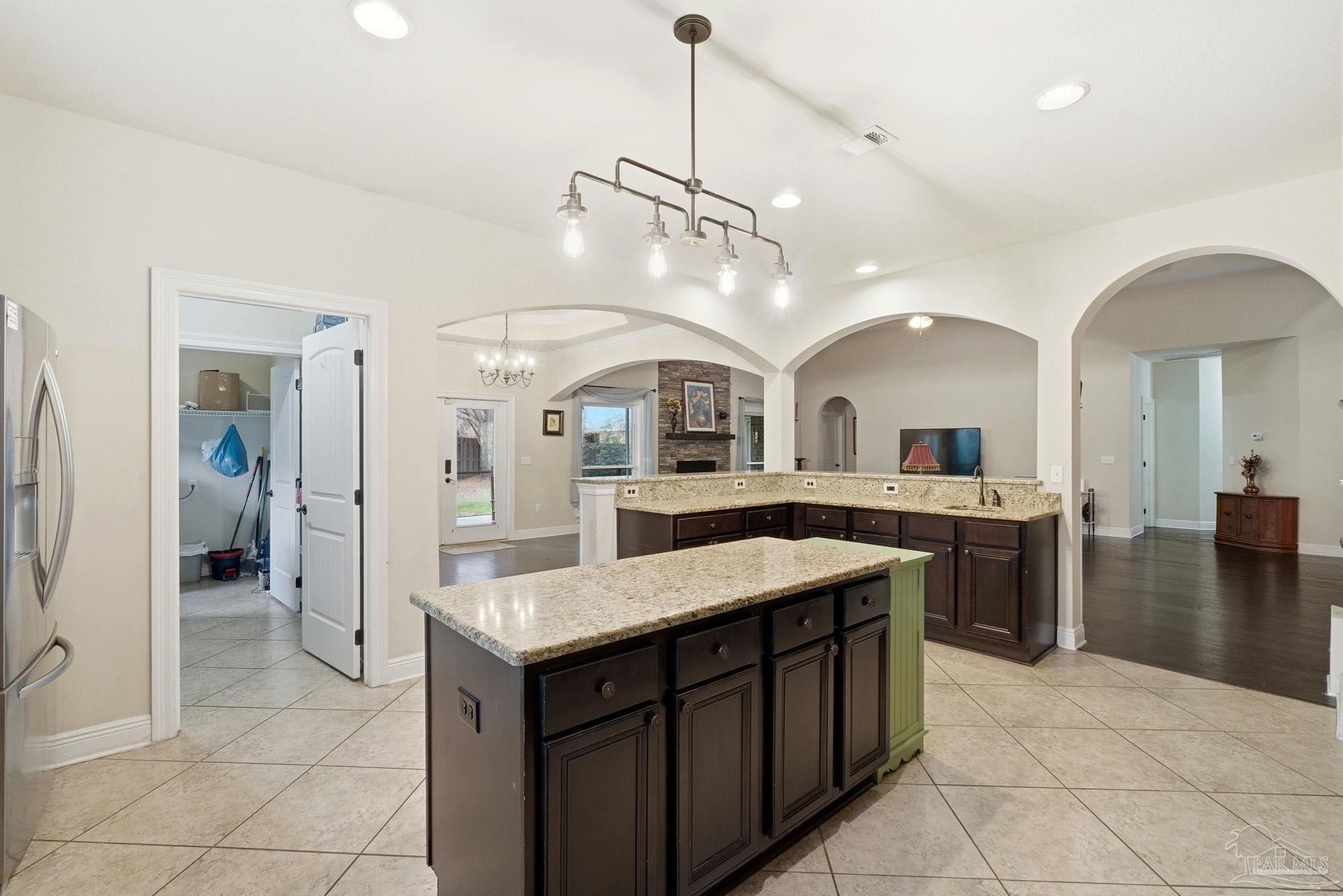 1207 Wings Way Cantonment, FL 32533 - Photo 12 of 39 a kitchen with a sink a counter top space and stainless steel appliances