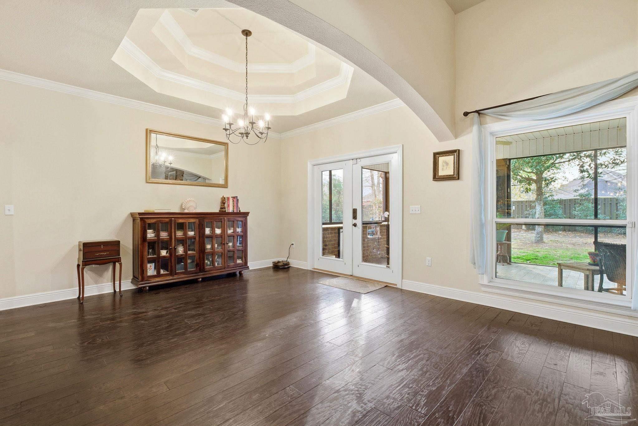 1207 Wings Way Cantonment, FL 32533 - Photo 14 of 39 a view of an empty room with wooden floor and a window