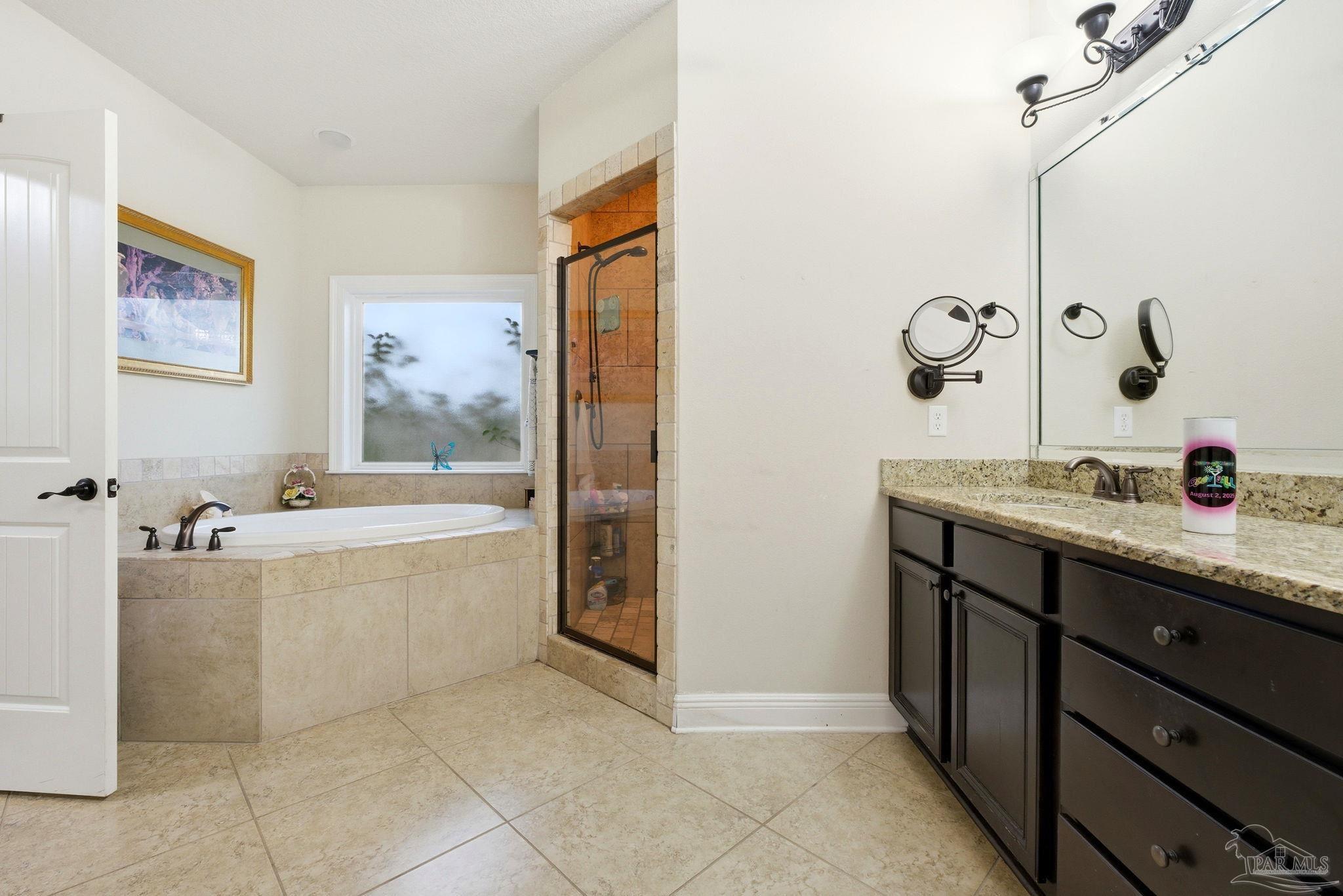 1207 Wings Way Cantonment, FL 32533 - Photo 20 of 39 a spacious bathroom with a tub sink and mirror