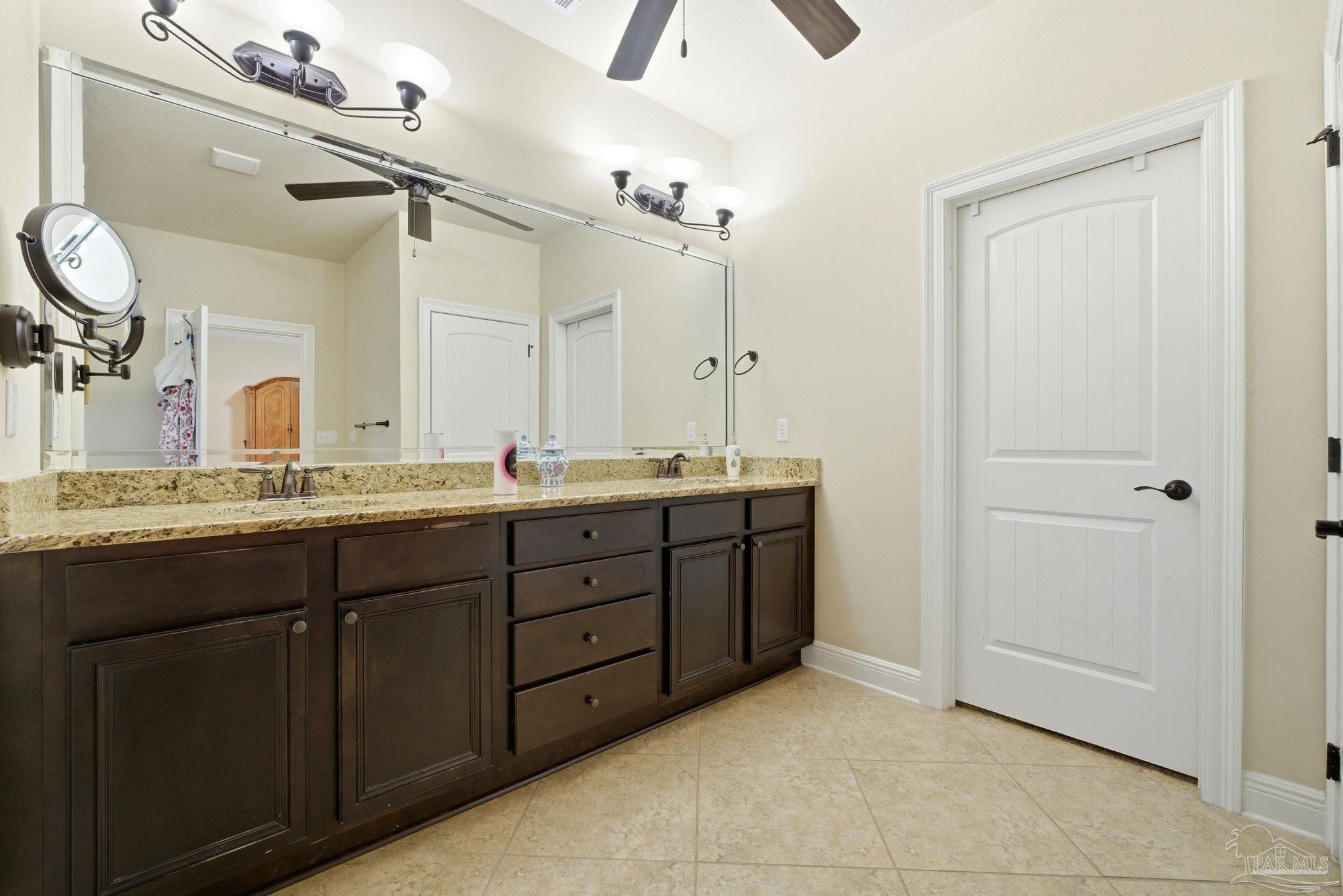 1207 Wings Way Cantonment, FL 32533 - Photo 21 of 39 a bathroom with a granite countertop sink a mirror and a vanity
