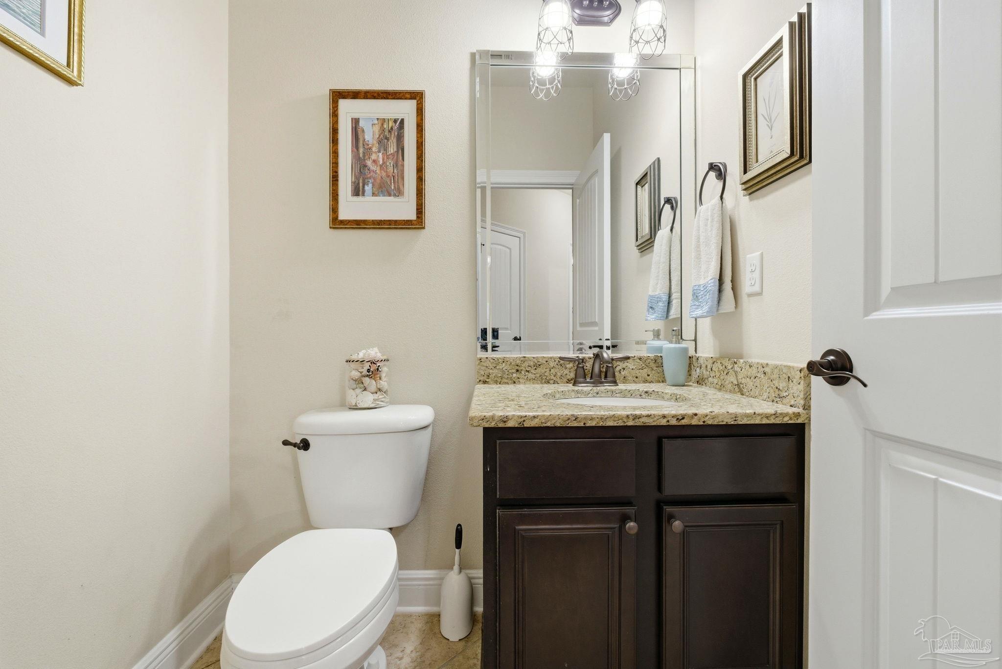1207 Wings Way Cantonment, FL 32533 - Photo 23 of 39 a bathroom with a granite countertop toilet sink and mirror
