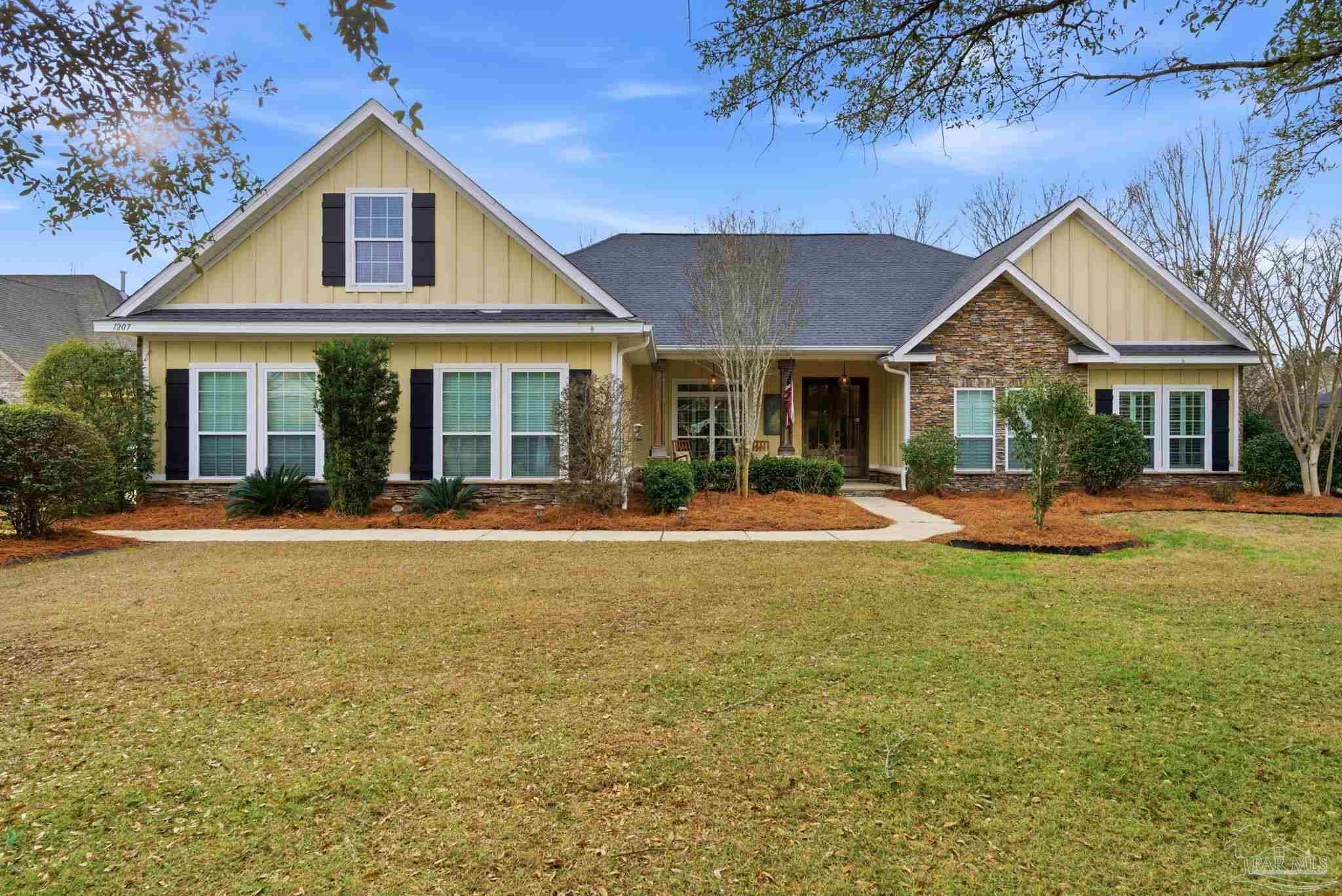 1207 Wings Way Cantonment, FL 32533 - Photo 3 of 39 a front view of a house with swimming pool