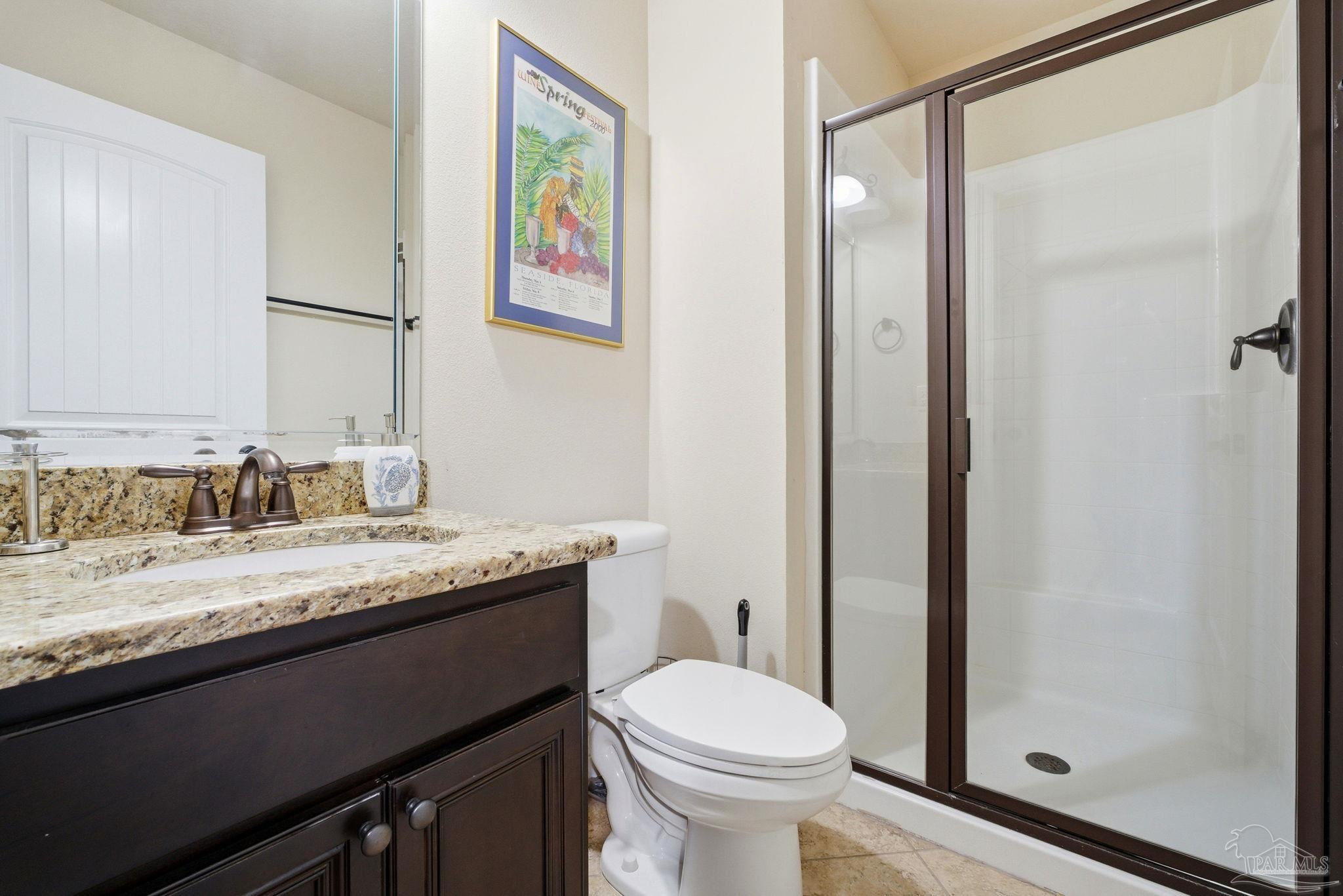 1207 Wings Way Cantonment, FL 32533 - Photo 31 of 39 a bathroom with a granite countertop sink a toilet and a mirror
