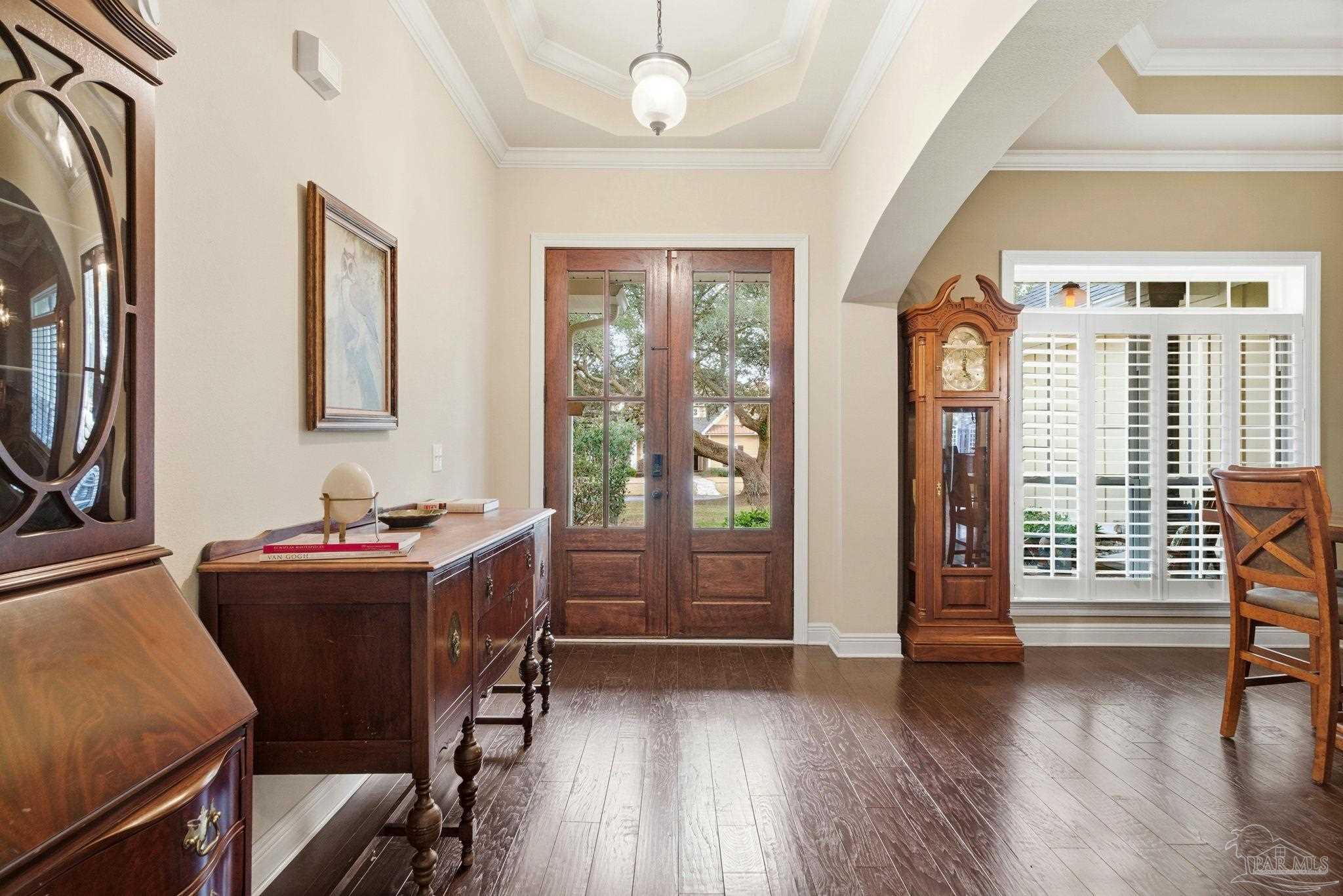 1207 Wings Way Cantonment, FL 32533 - Photo 5 of 39 a dining room with wooden floor and furniture