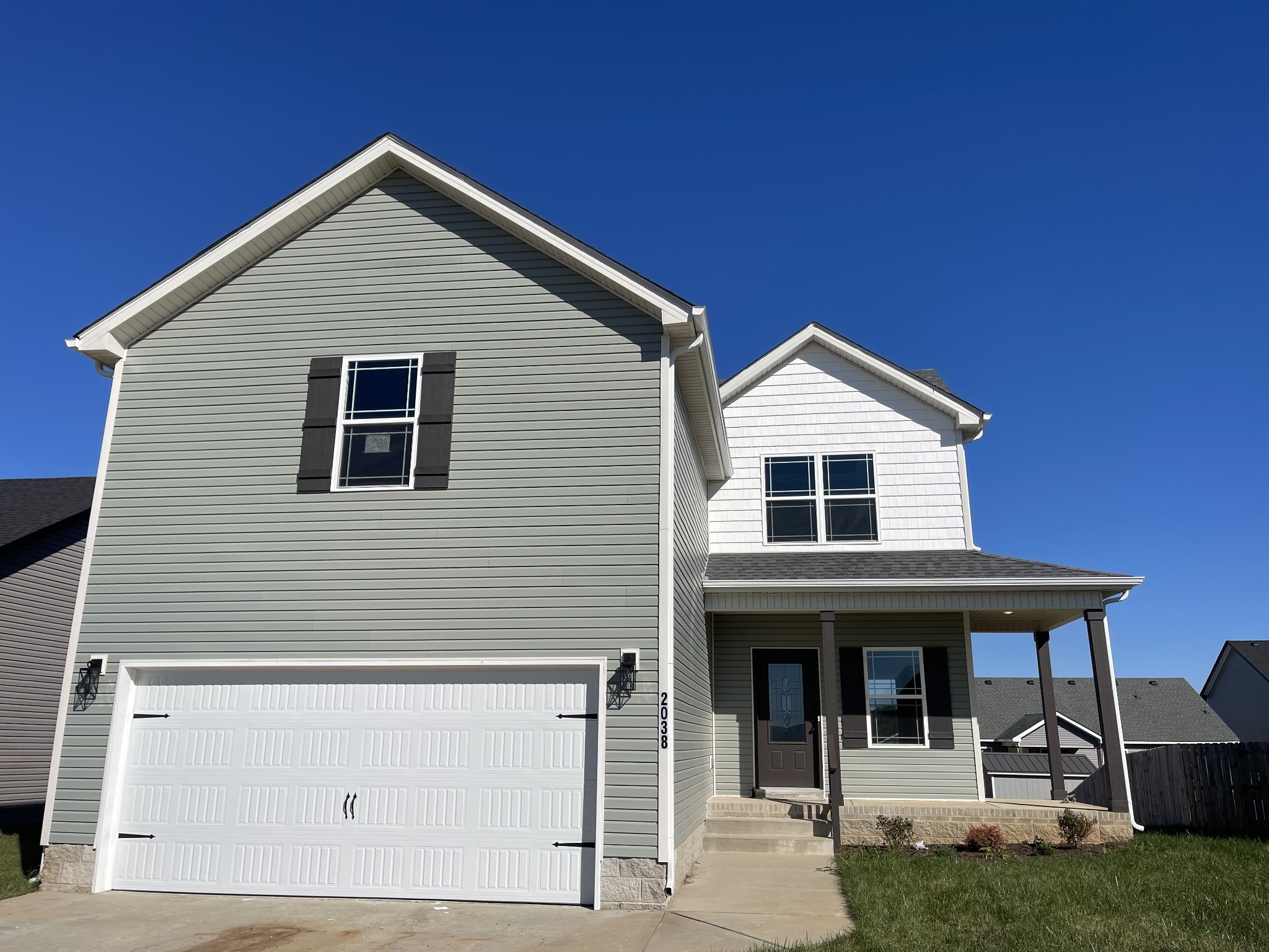 a front view of white house with a yard