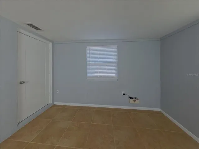 a view of an empty room with a window