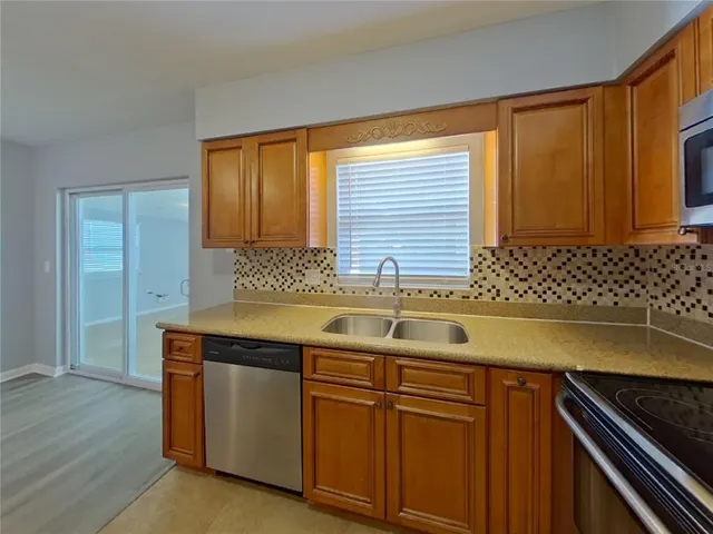 a kitchen with granite countertop cabinets sink and window