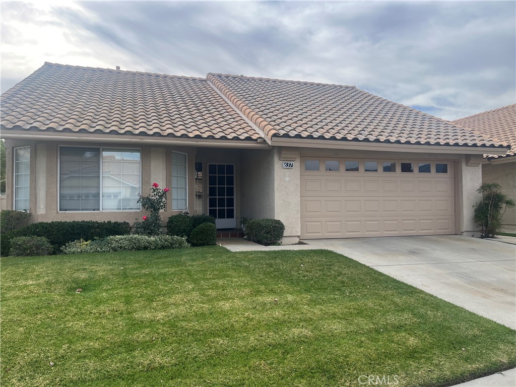 637 Torrey Pines Road Banning, CA 92220 - Photo 1 of 24 a front view of a house with a garden and plants