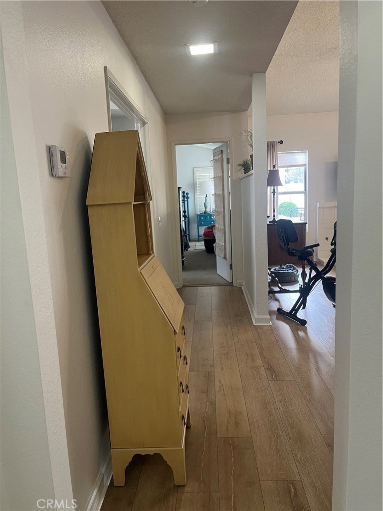 637 Torrey Pines Road Banning, CA 92220 - Photo 12 of 24 a view of a hallway with wooden floor and a bathroom