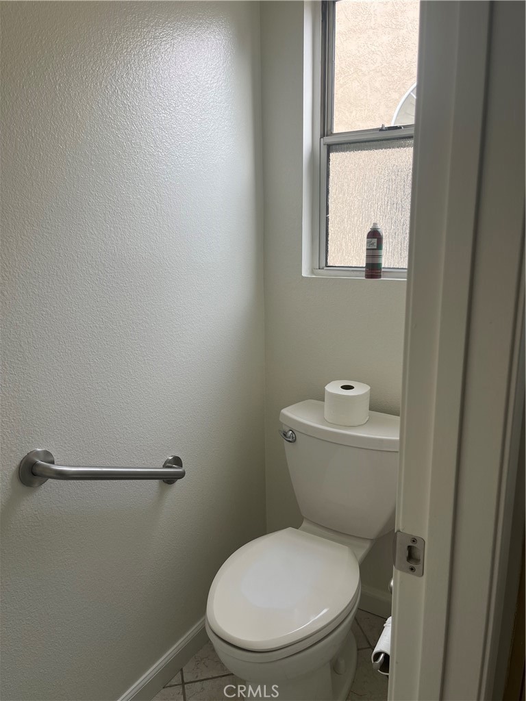 637 Torrey Pines Road Banning, CA 92220 - Photo 17 of 24 a white toilet sitting next to a window in a bathroom