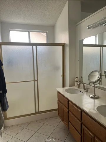 a bathroom with a double vanity sink and mirror