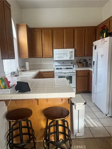 a kitchen with stainless steel appliances a stove a sink and a refrigerator