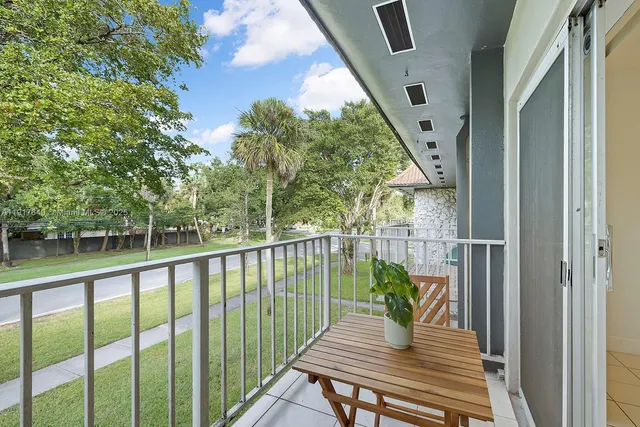 a view of balcony with wooden floor and seating space