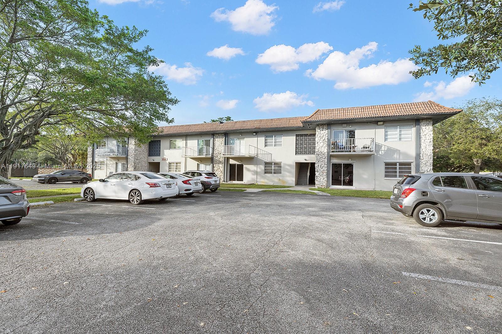 6530 Lake Patricia Drive, Unit E25 Miami Lakes, FL 33014 - Photo 15 of 16 a car parked in front of a house