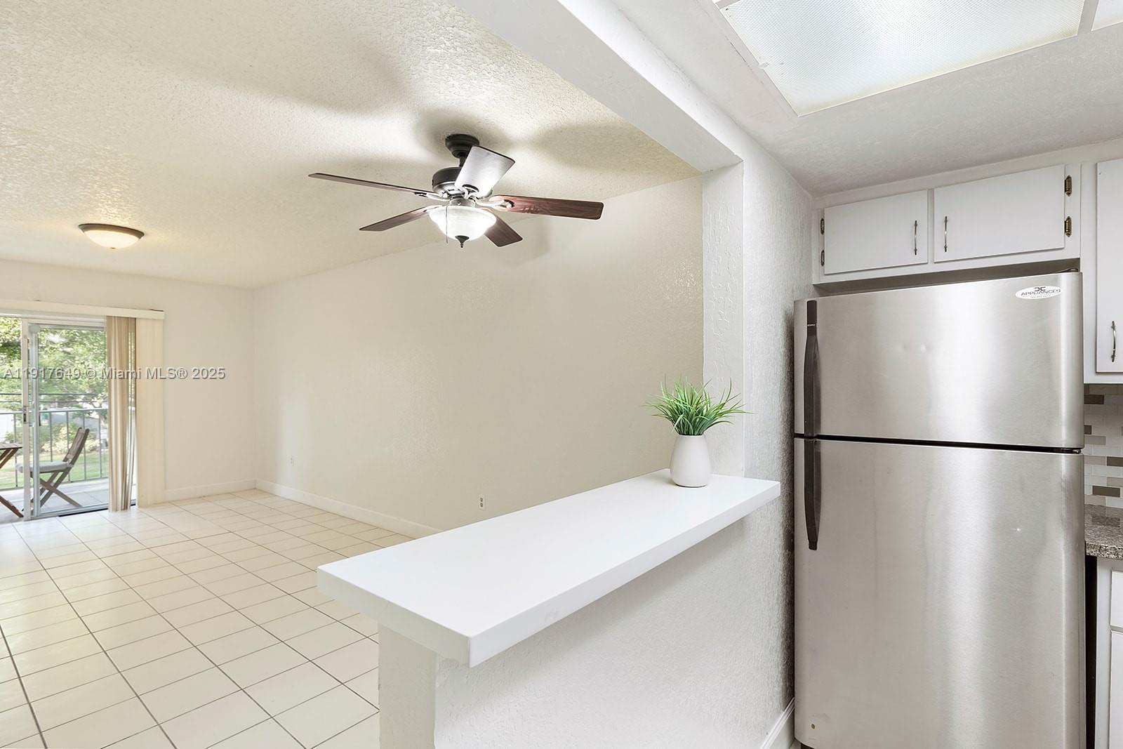 6530 Lake Patricia Drive, Unit E25 Miami Lakes, FL 33014 - Photo 2 of 16 a white refrigerator freezer sitting in a kitchen
