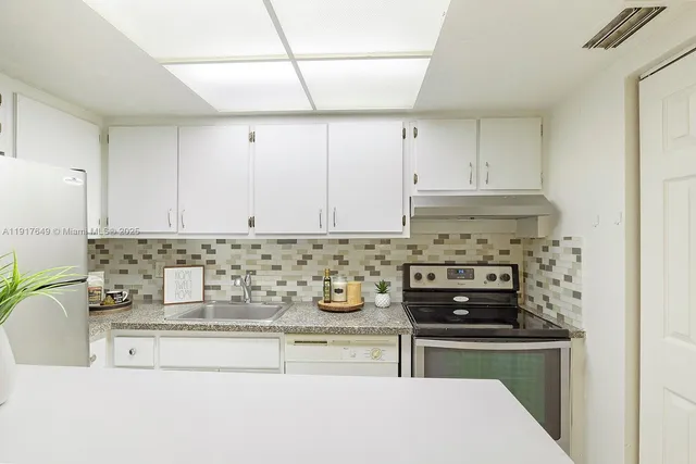 a kitchen with a stove and a cabinets