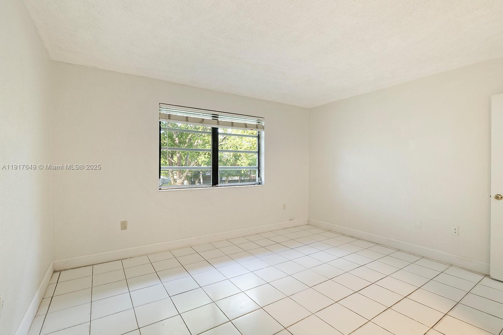 6530 Lake Patricia Drive, Unit E25 Miami Lakes, FL 33014 - Photo 8 of 16 an empty room with windows