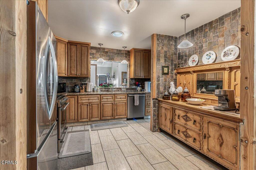 541 Broderick Way Port Hueneme, CA 93041 - Photo 16 of 35 a kitchen with stainless steel appliances granite countertop a sink and cabinets