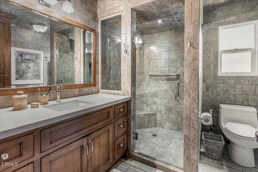 541 Broderick Way Port Hueneme, CA 93041 - Photo 24 of 35 a bathroom with a granite countertop sink a toilet a mirror and shower