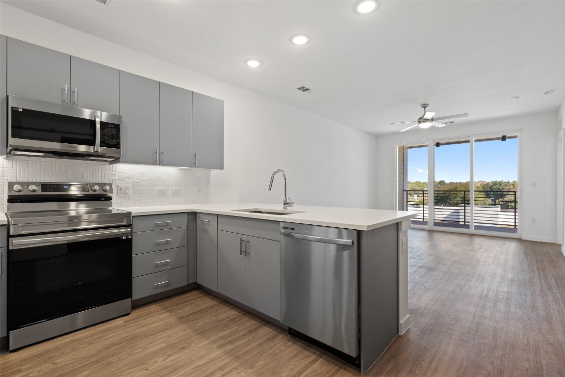 4801 Springdale Road, Unit 2307 Austin, TX 78723 - Photo 1 of 1 a kitchen with stainless steel appliances granite countertop a sink and stove top oven