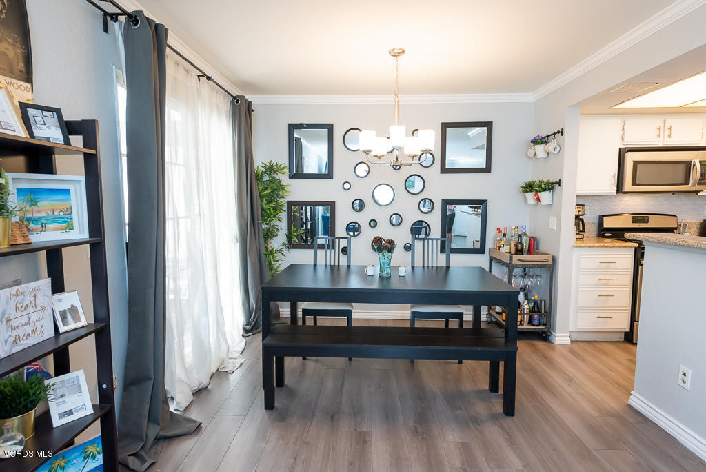 1135 Fitzgerald Road, Unit A Simi Valley, CA 93065 - Photo 11 of 49 a view of a dining room with furniture a chandelier and wooden floor