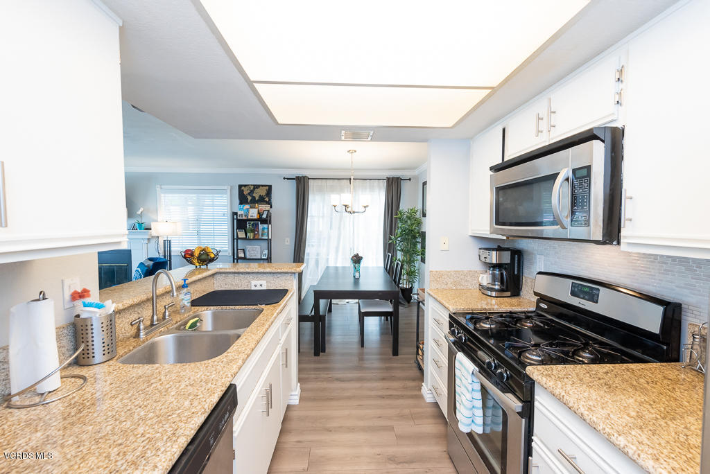 1135 Fitzgerald Road, Unit A Simi Valley, CA 93065 - Photo 15 of 49 a kitchen with granite countertop a stove and a sink